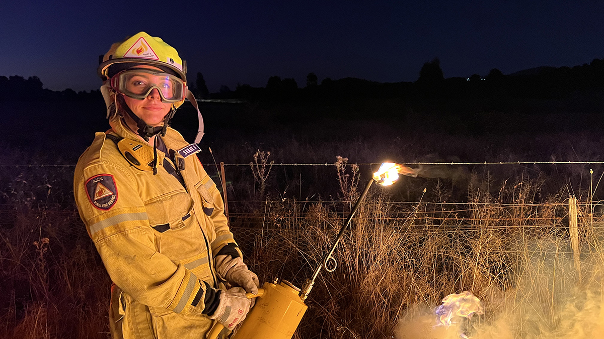 A firefighter holding a flaming torch